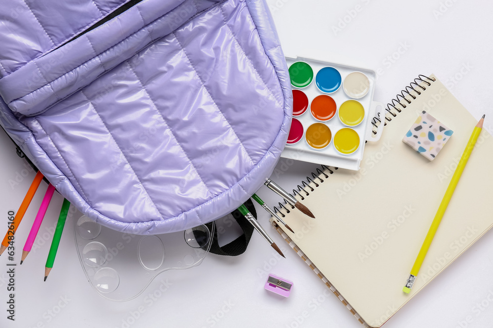 Stylish school backpack with different stationery supplies on white background