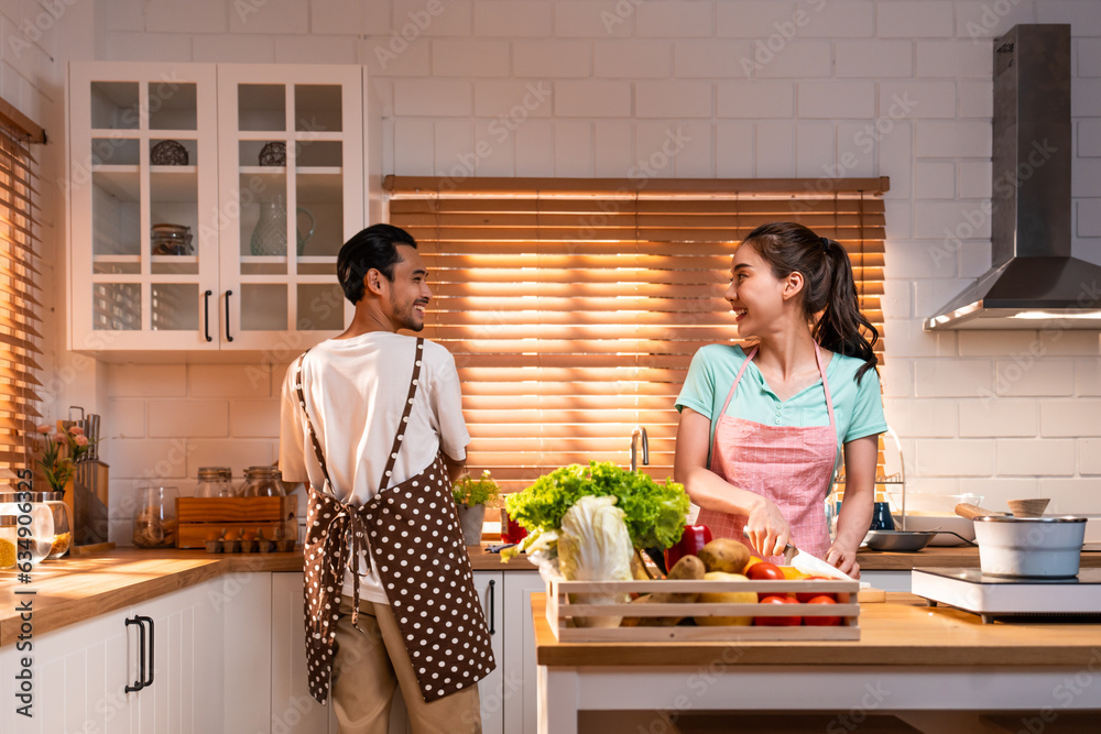 Asian young new marriage couple spend time together in kitchen at home. 