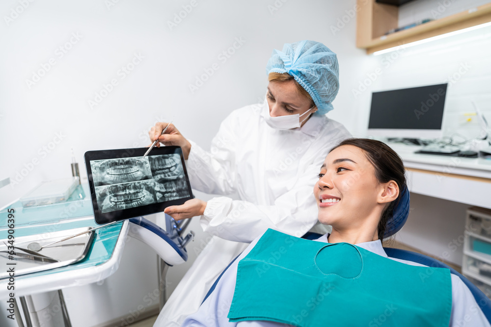 Caucasian dentist examine tooth for young girl at dental health clinic. 