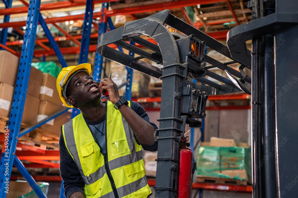 African American man industry worker working alone in factory warehouse. 