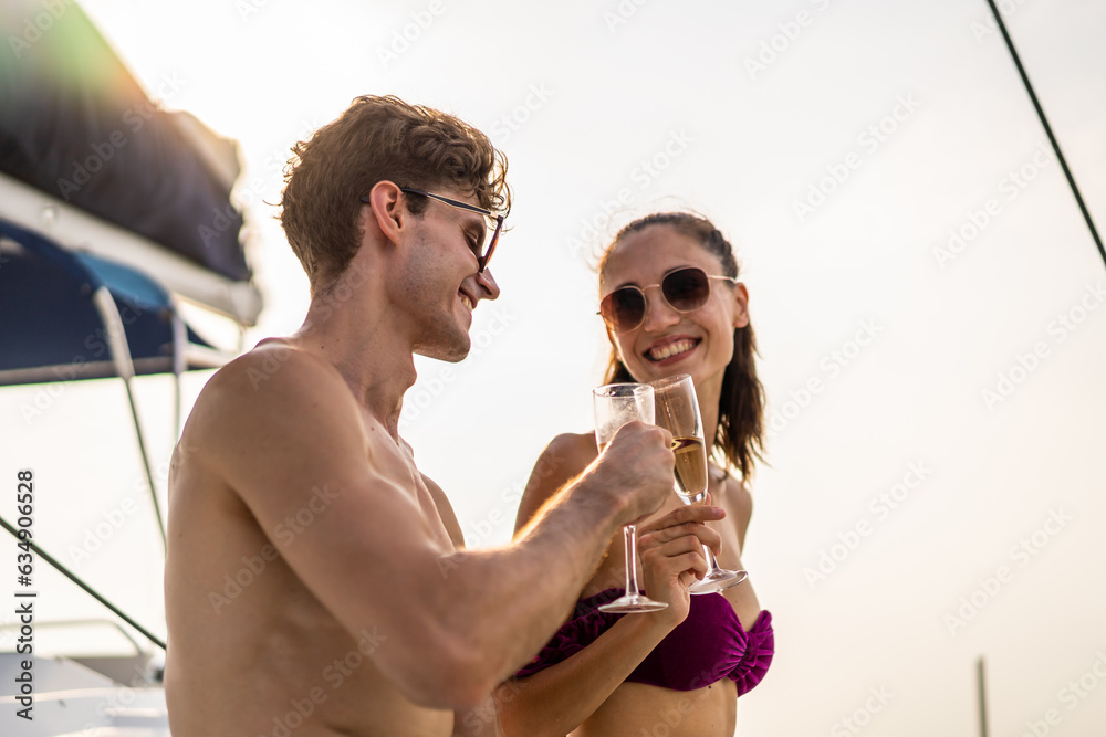 Caucasian young couple drink a bottle of beer, having party in yacht. 