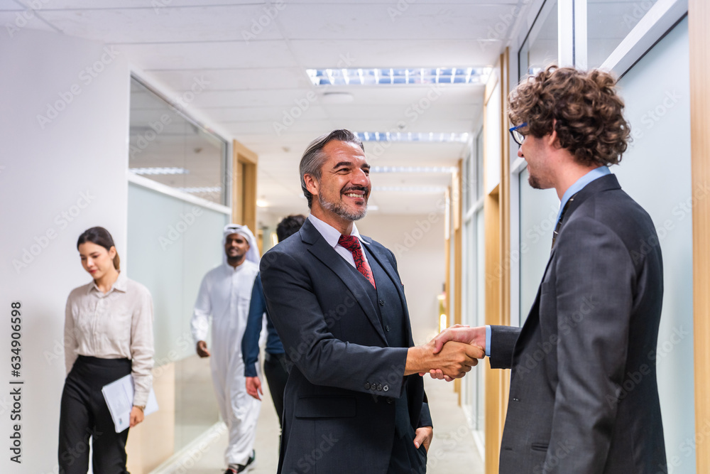 Caucasian businessman making a handshake together while stand in office. 