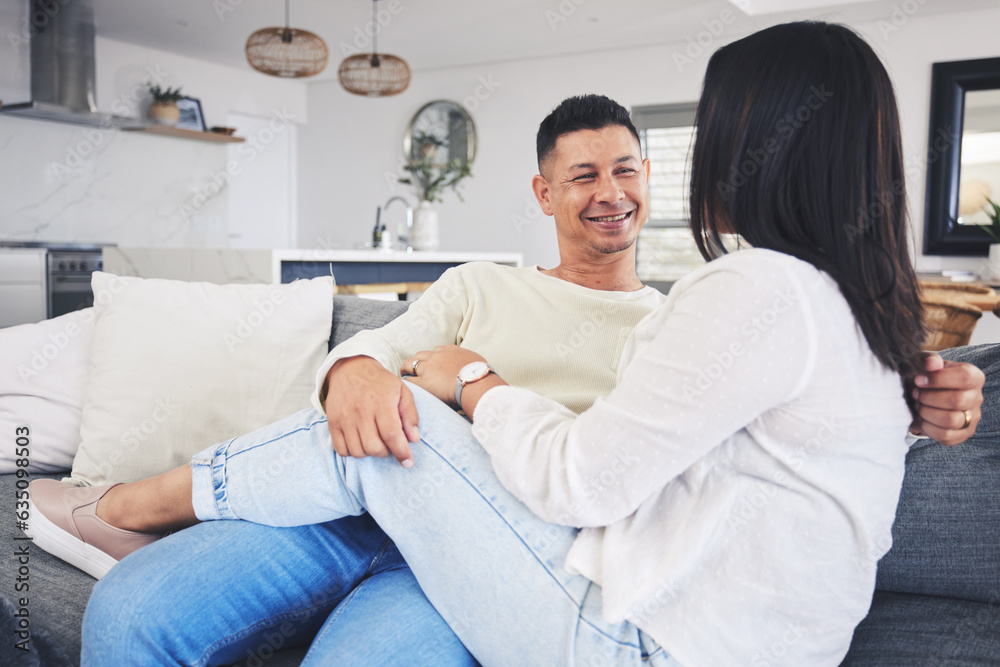 Conversation, relax and couple on a sofa in the living room talking and bonding together at home. Ha