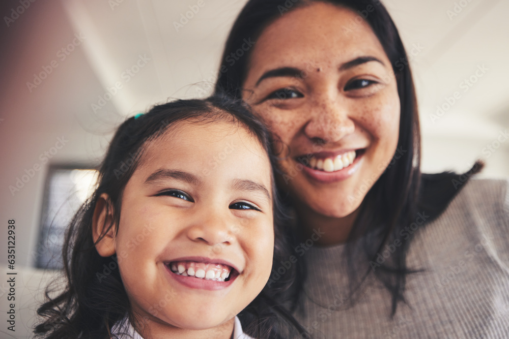 Selfie, smile and portrait of a girl with her mother bonding in the living room of their home. Happy