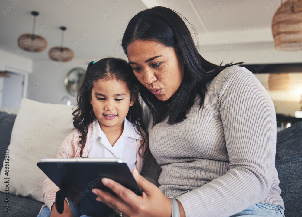 Tablet, study and a mother on the sofa with her daughter in the living room of their home together. 