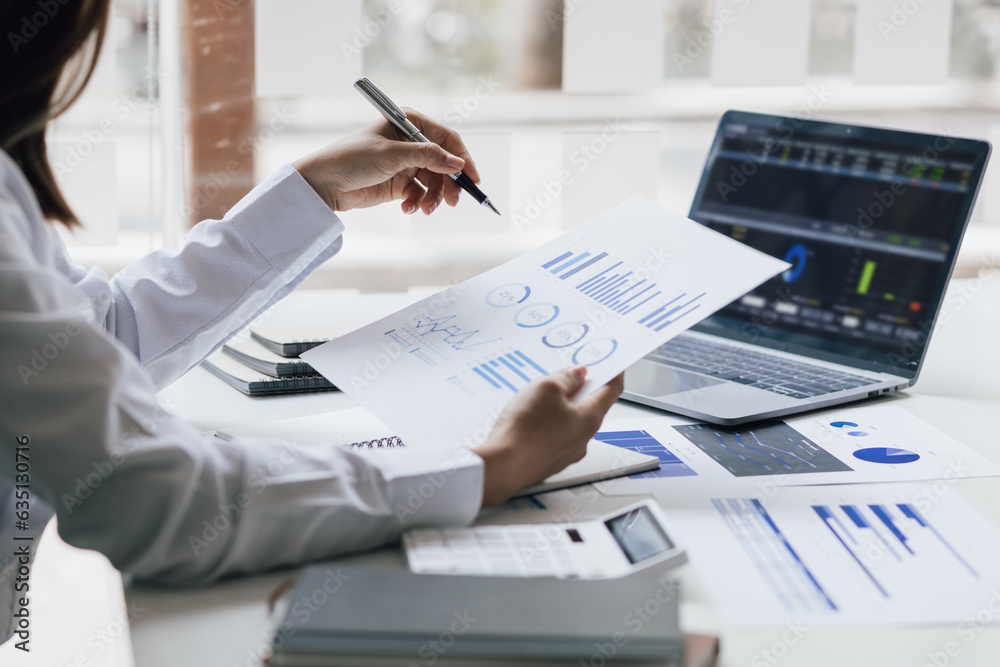 Businesswoman working with laptop and analyzing financial and accounting documents. Business woman w