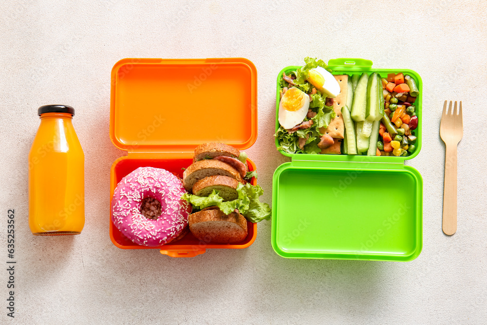 Lunchboxes with different delicious food and bottle of juice on light background