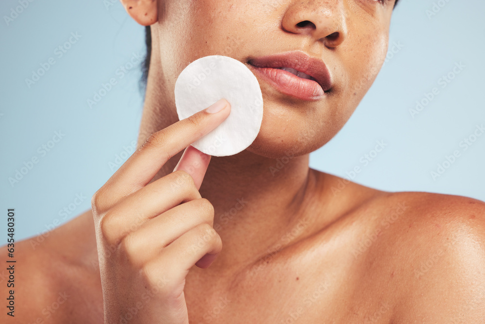 Woman, cotton pad and closeup of face for cosmetics, aesthetic glow and grooming on studio backgroun