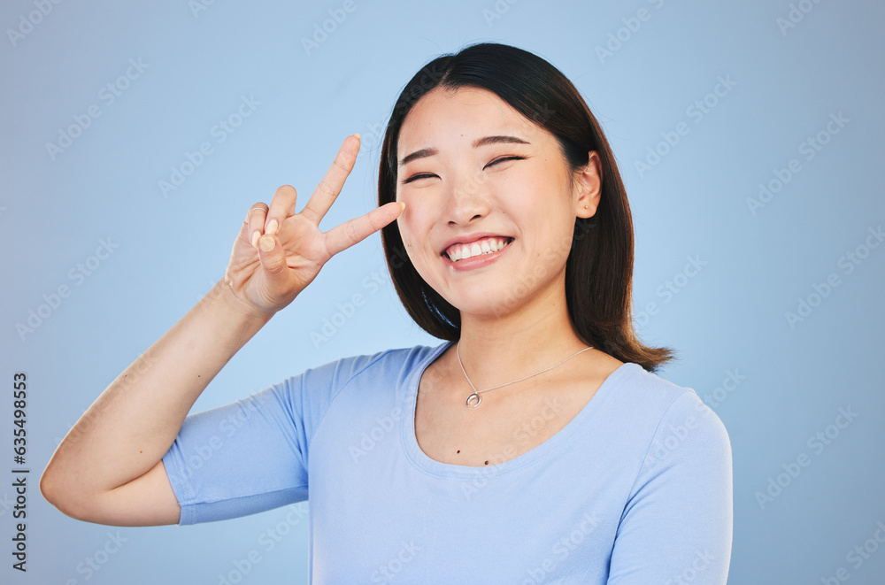 Peace, sign and portrait of woman with hand for emoji in studio blue background with gen z style, fa