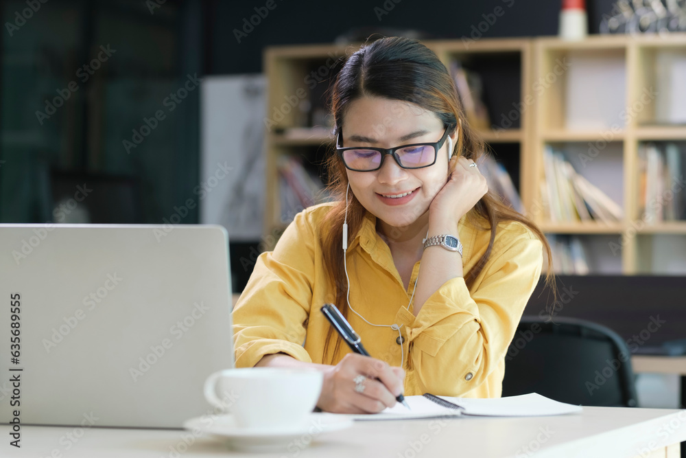 Digital Learning: Woman Wearing Headphones Engaged in Online Education