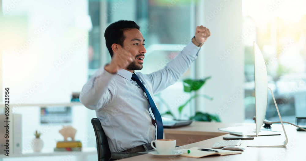 Excited business man cheering at his desk. Successful male banker or happy financial advisor celebra