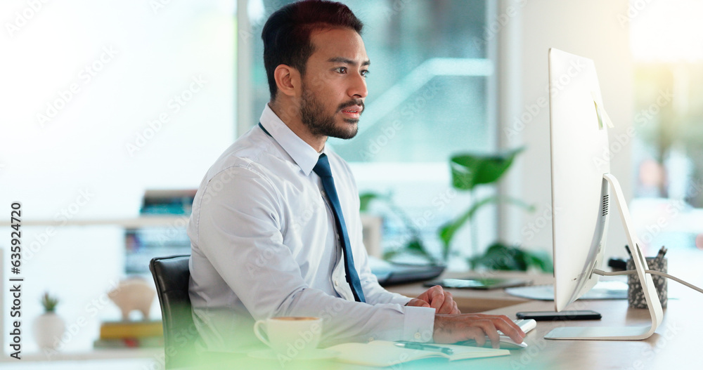 Busy male Accountant typing an email in a modern office. A financial advisor compiling a finance pro