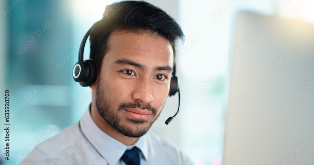 Call center agent talking and listening to a client on a headset while working in an office. Confide