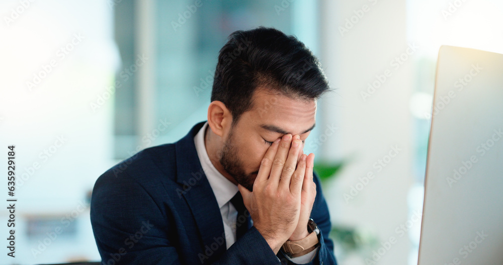 Stressed web developer suffering with mental block while trying to code on a computer in his office.