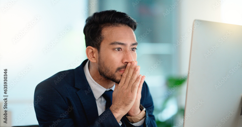 Stressed web developer suffering with mental block while trying to code on a computer in his office.