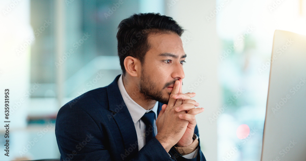 Stressed web developer suffering with mental block while trying to code on a computer in his office.