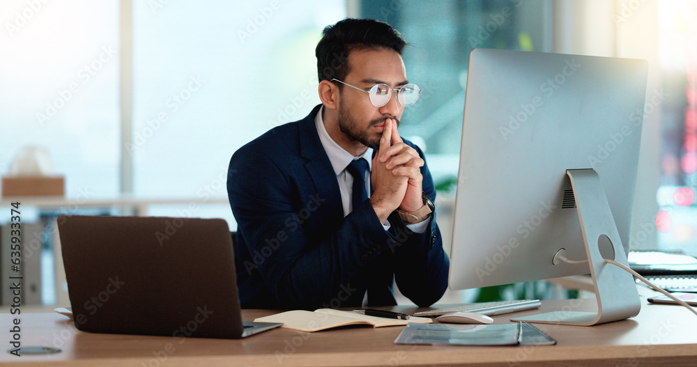 Business man analyzing a project strategy on a computer screen while working in an office. Serious a