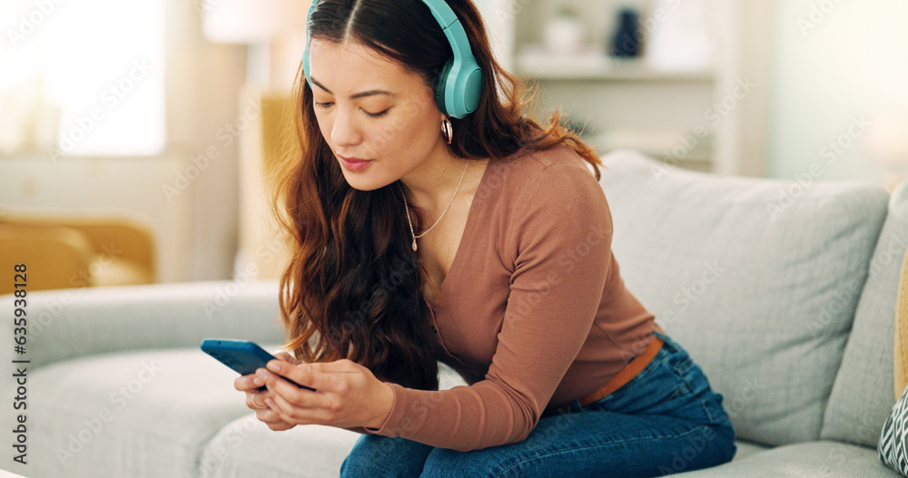 Woman, phone or music headphones on relax sofa in house or Singaporean home living room. Smile,enjoy