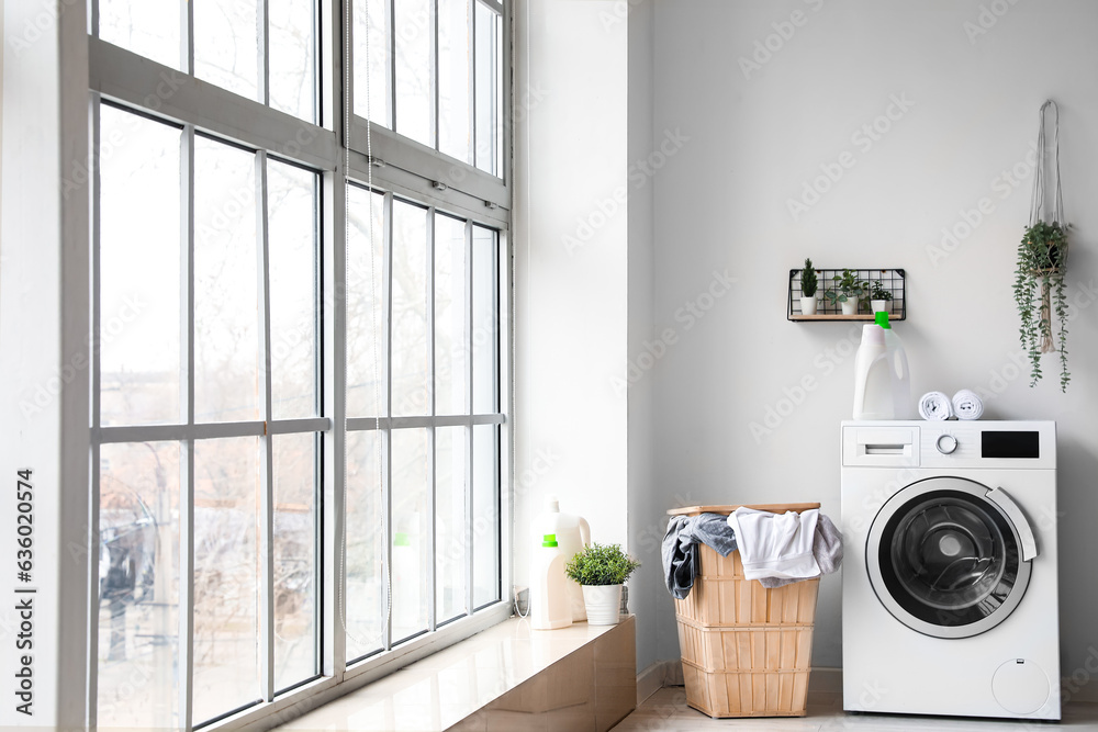 Interior of laundry room with washing machine and basket