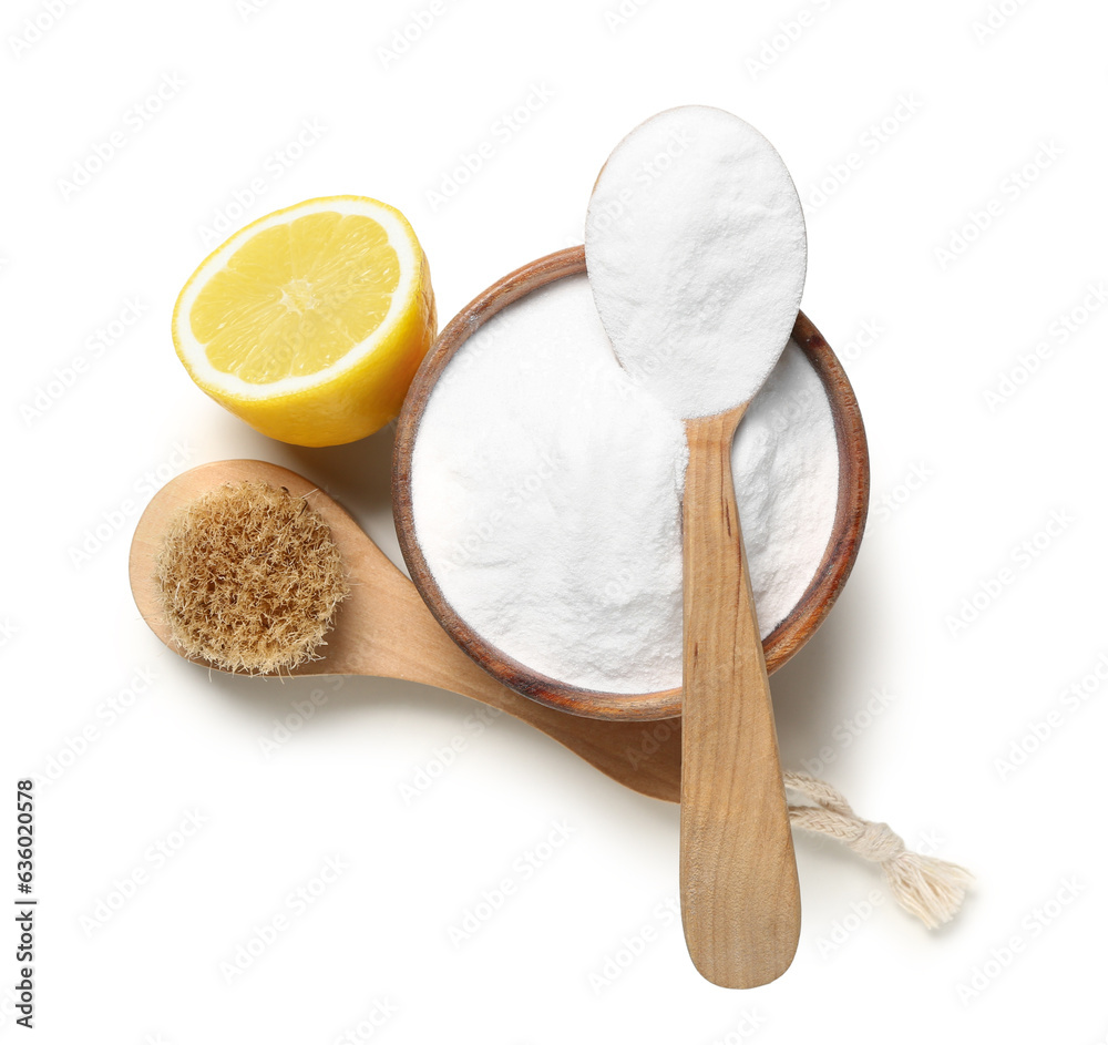 Bowl of baking soda, cleaning brush and lemon on white background