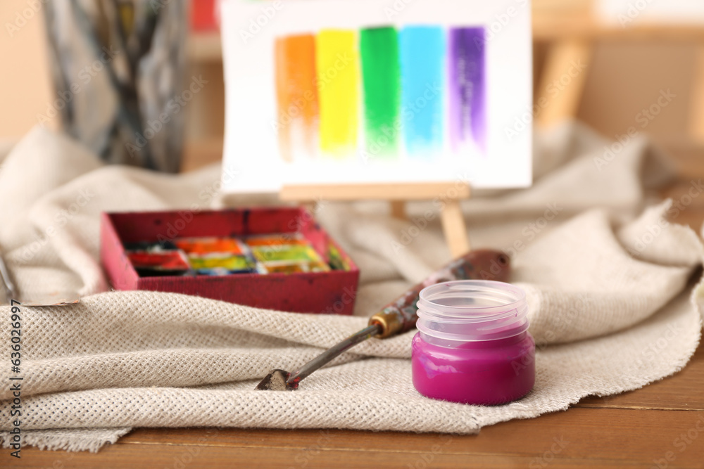 Jar of pink paint in artists studio