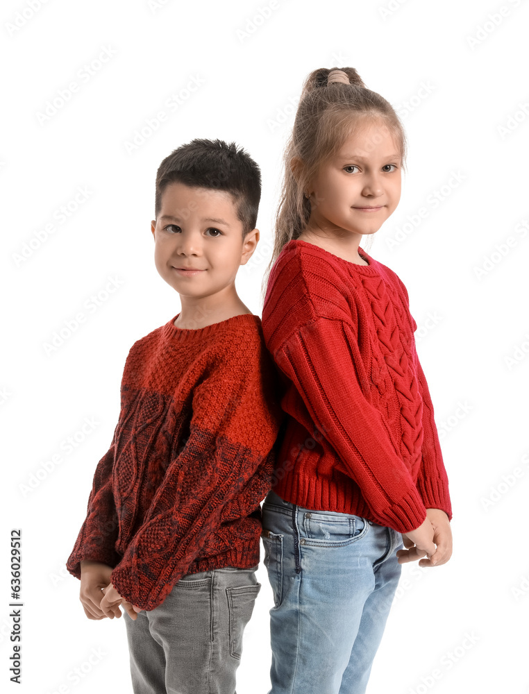 Cute little children in knitted sweaters on white background