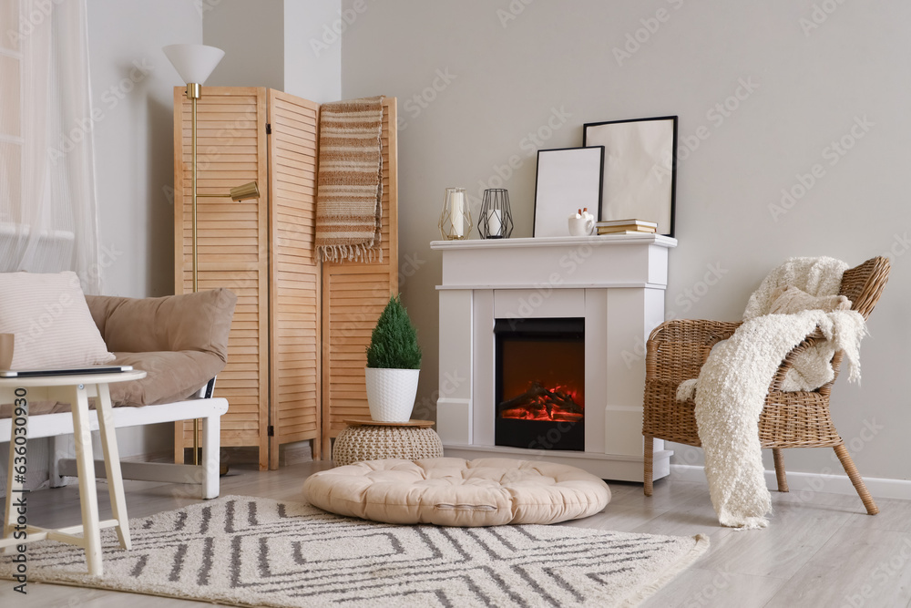 Interior of cozy living room with fireplace and armchair