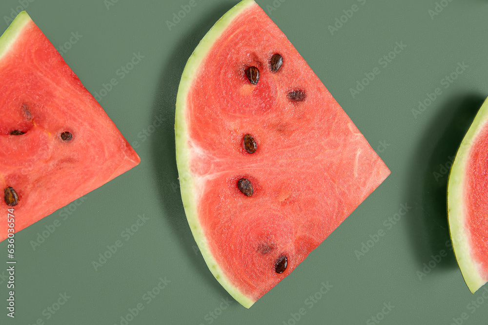 Pieces of ripe watermelon on green background, closeup