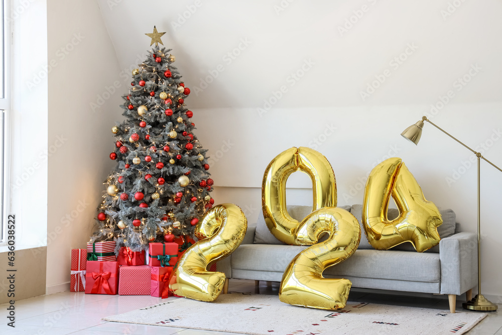 Balloons in shape of figure 2024 on grey sofa in living room with Christmas decor