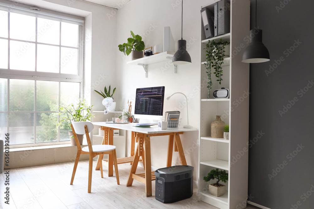 Programmers workplace with computer in interior of light office