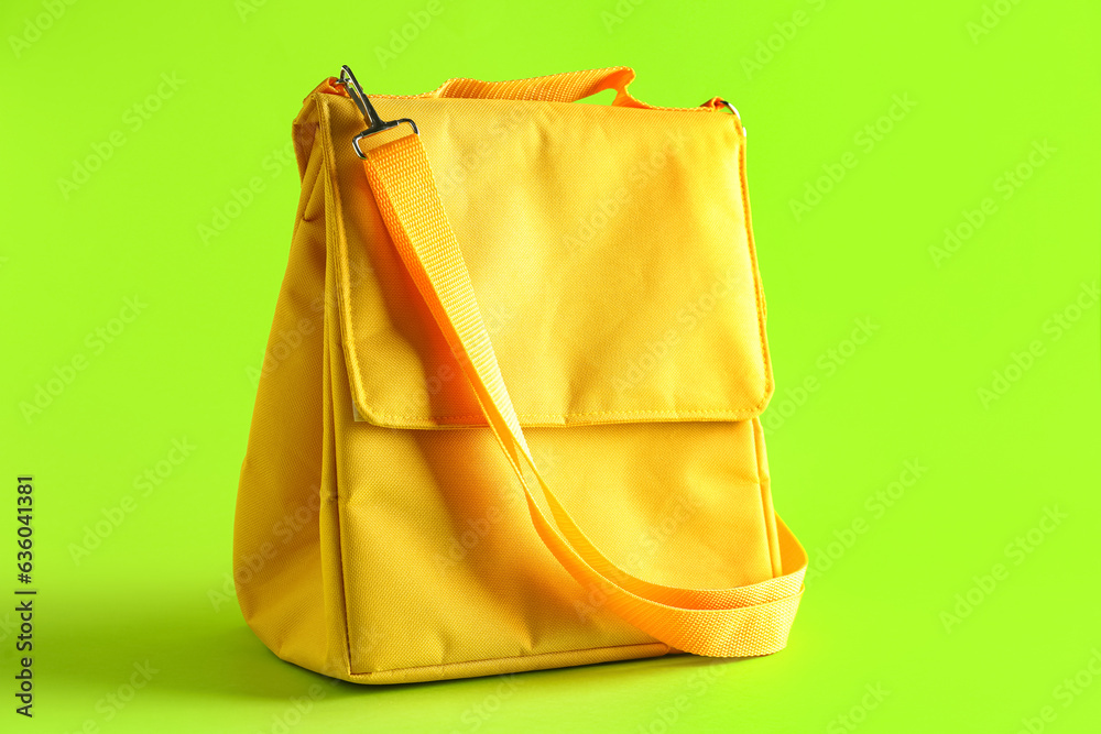 Yellow lunch box bag on green background