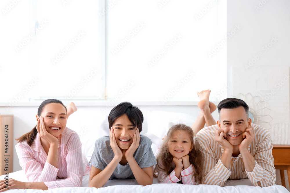 Little children with their parents in bedroom