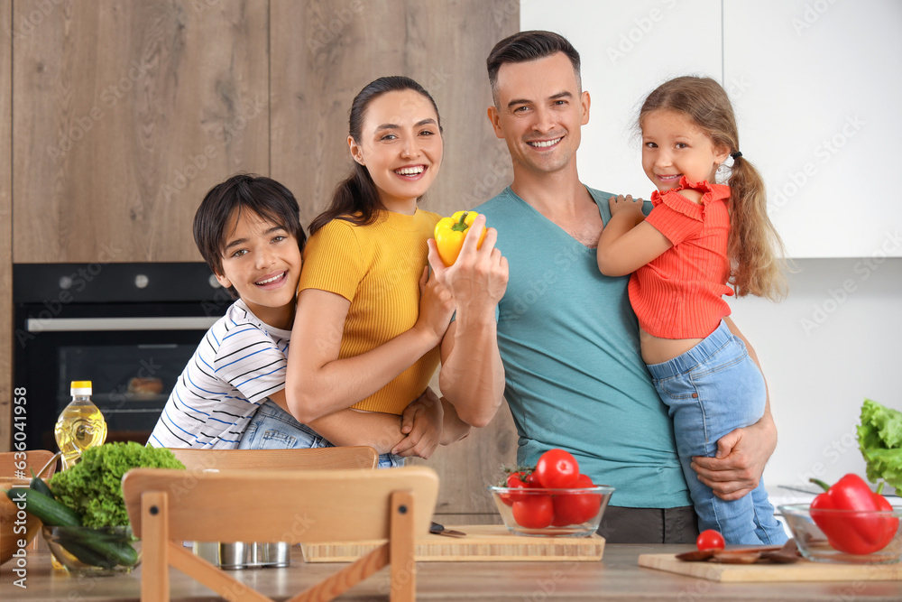 Little children with their parents cooking in kitchen