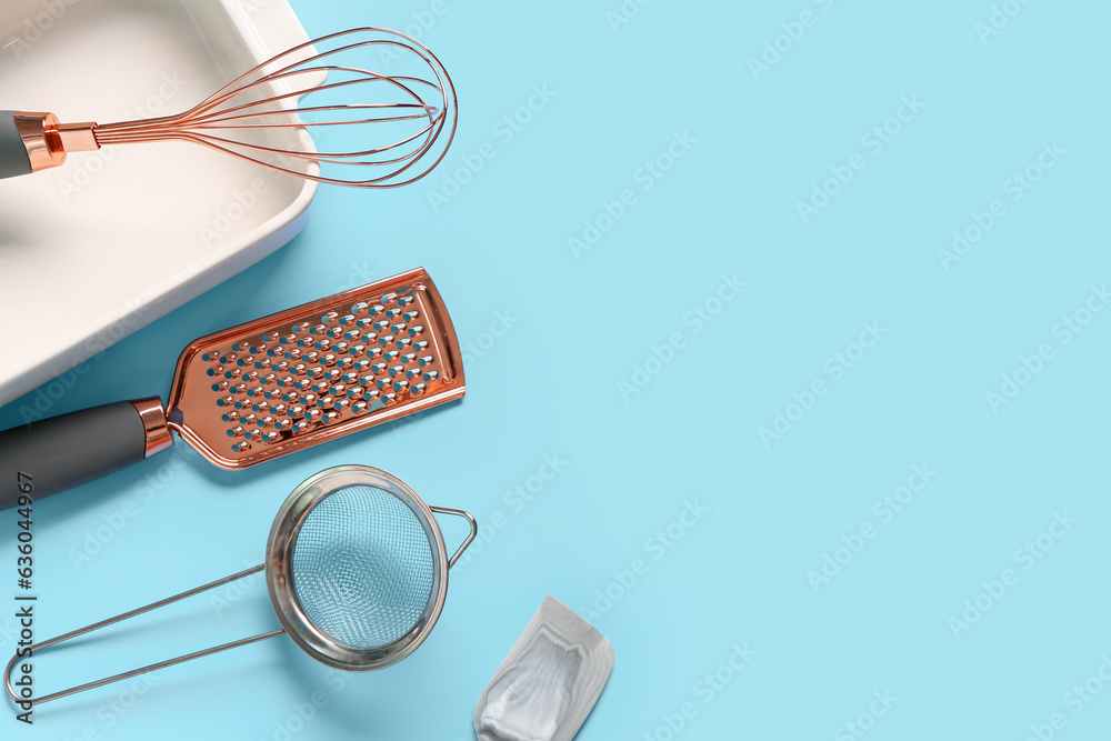 Baking form and utensils on blue background