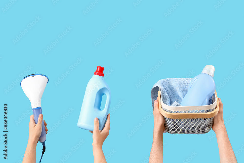 People with bottles of laundry detergent, basket and steamer on blue background