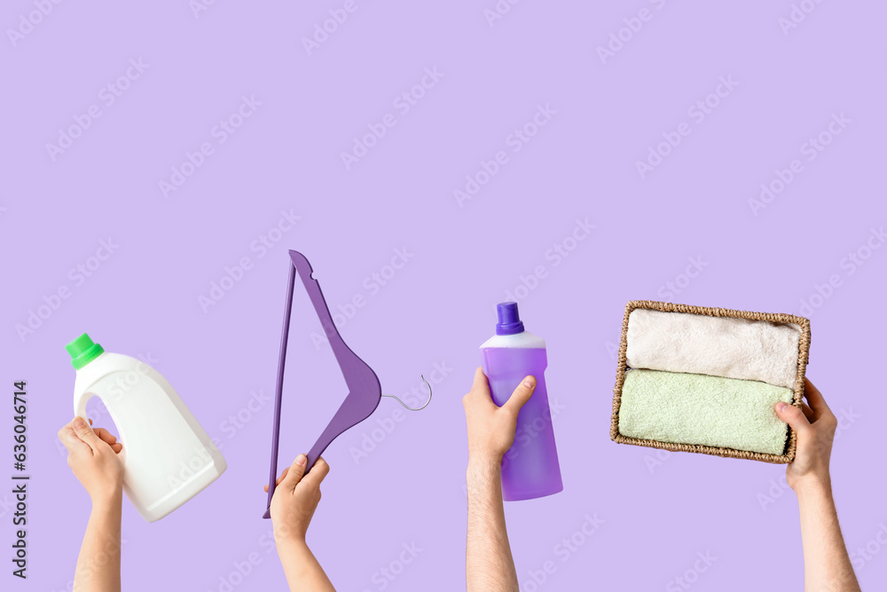 People with bottles of laundry detergent, hanger and clean towels on lilac background