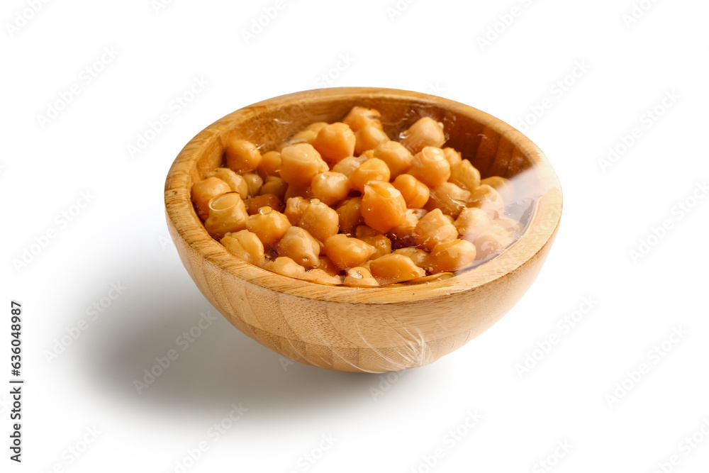 Bowl of fresh chickpeas covered with plastic food wrap on white background