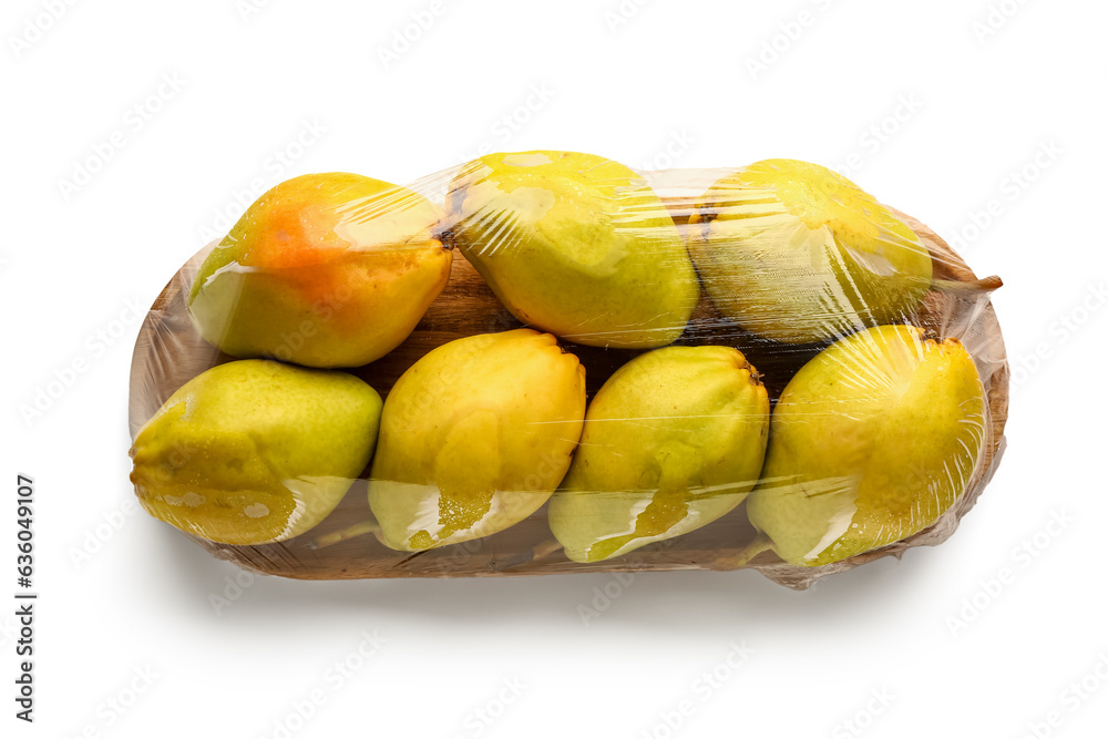 Wooden board of fresh pears covered with plastic food wrap on white background