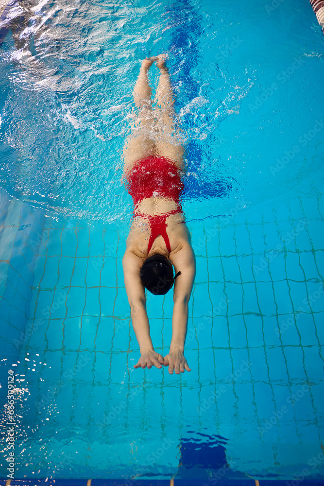 Experienced sportswoman exercising alone in sports pool