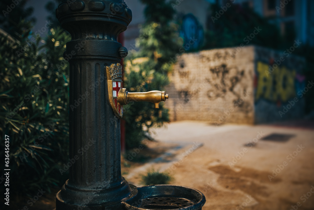 Drinking water fountain on the street of a European city at night