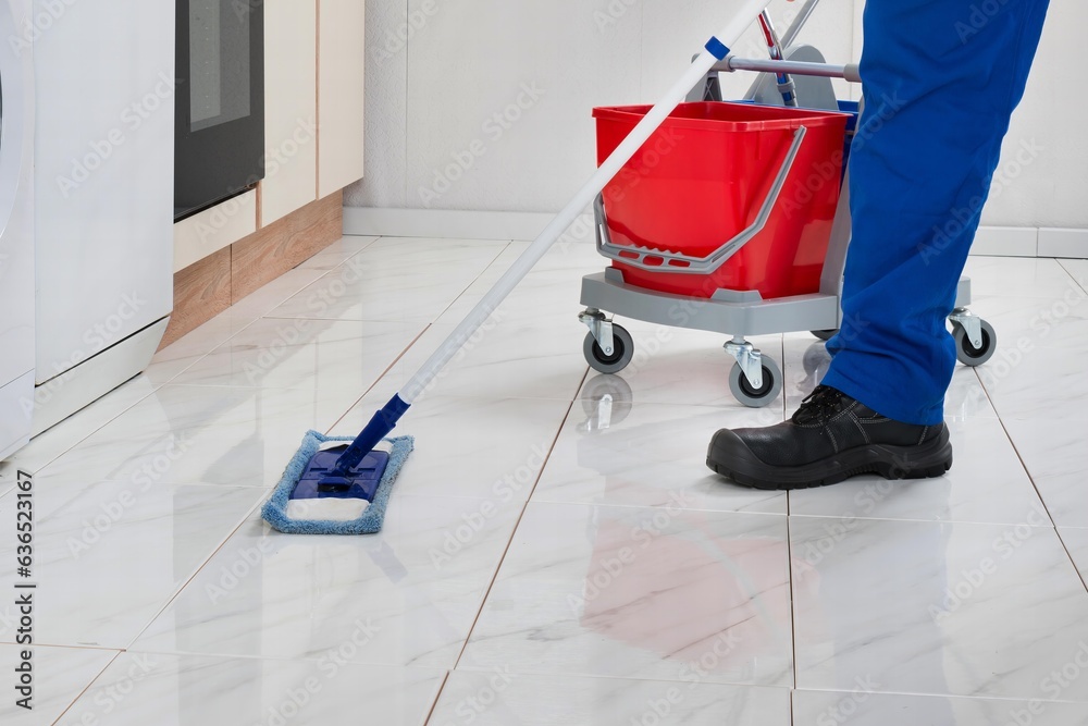 Worker Cleaning Floor In Kitchen Room