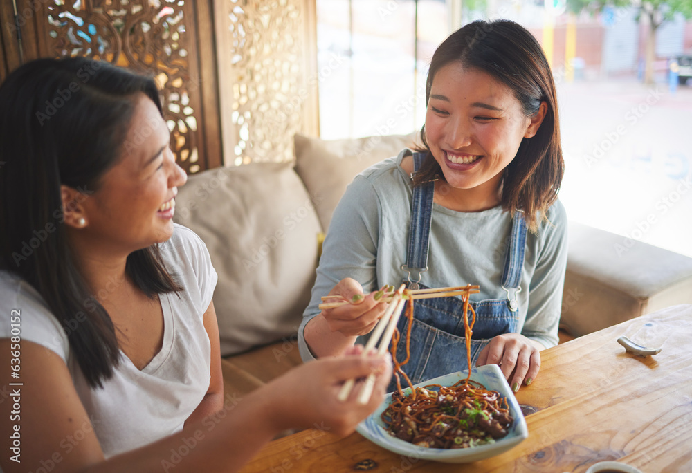 Chopsticks, restaurant and girl friends eating noodles and Asian cuisine at a cafe. Happy, hungry wo