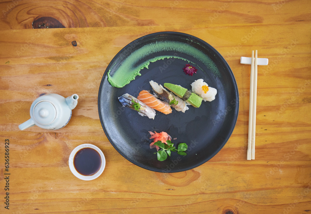 Sushi, food and chopsticks in an asian restaurant from above for fine dining or traditional cuisine.