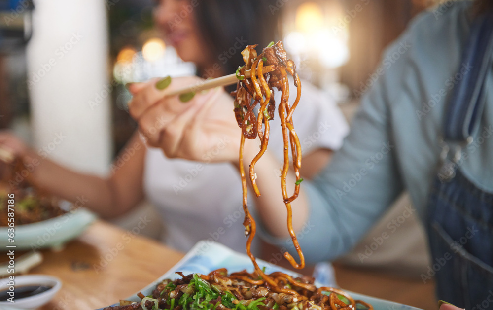 Food, woman and hand with chopsticks in restaurant eat spaghetti and snack alone at table in closeup