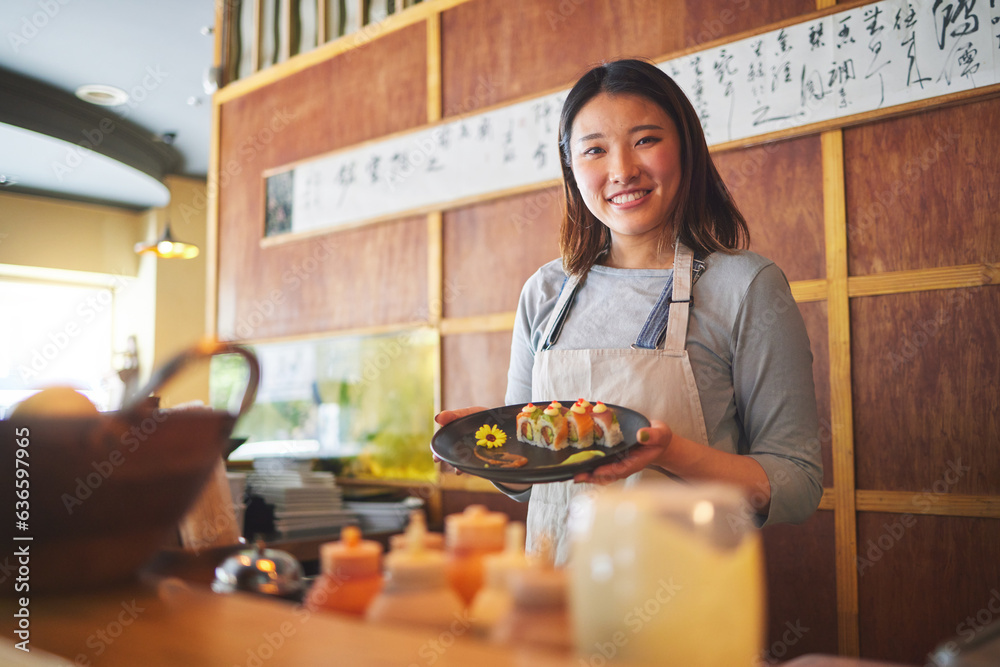 Sushi restaurant, portrait and female waitress with a plate for serving a food order with a smile. H