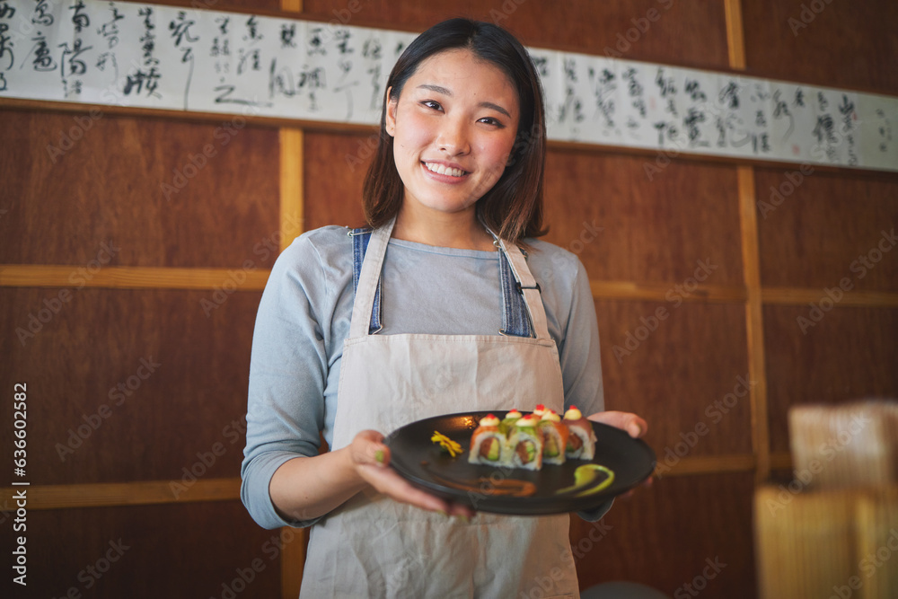 Restaurant, portrait and female waitress with sushi for serving a food order with a smile. Happy, lu