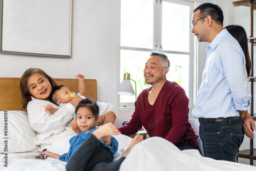 Portrait of happy love asian grandfather with grandmother playing with asian baby and little cute gi