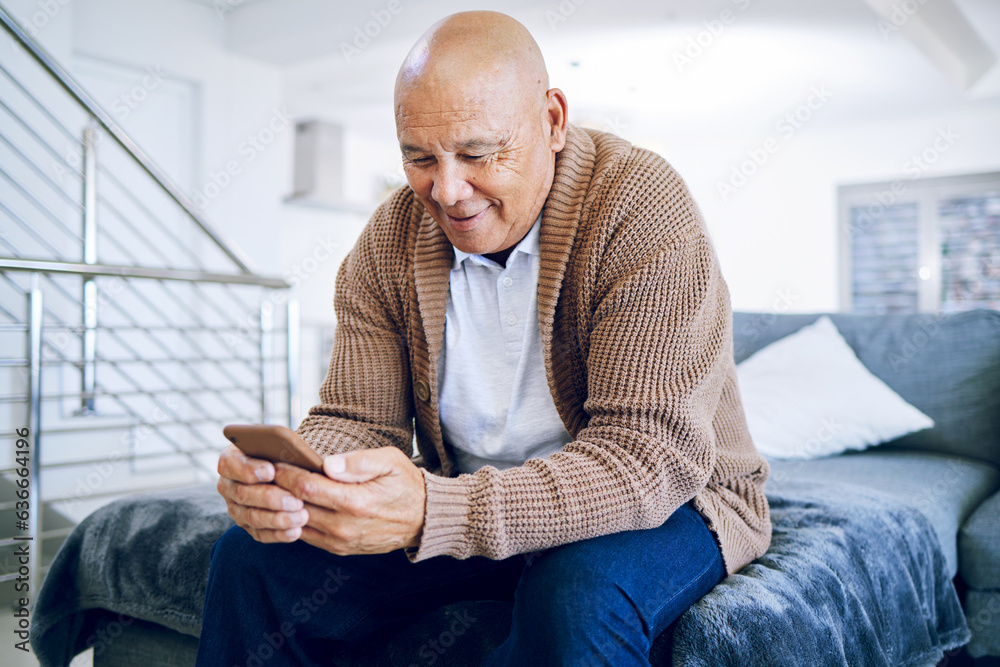 Old man on bed with phone, smile and typing message, communication and technology in retirement. Soc