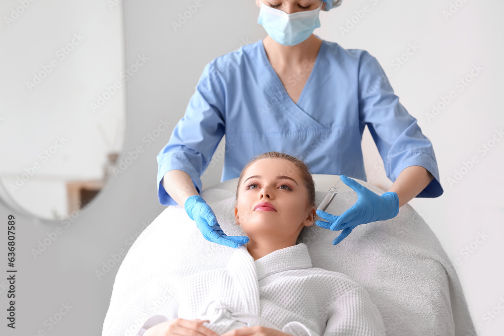 Young woman undergoing treatment in beauty salon. Skin care concept