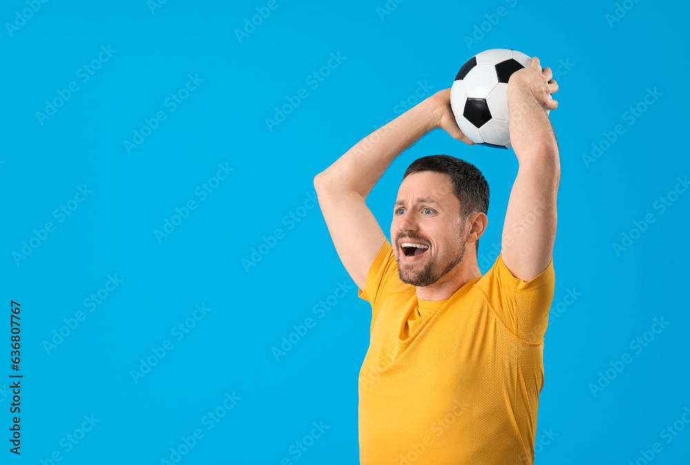 Man with soccer ball on blue background